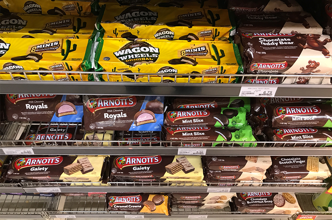 A photo of a a range of Arnott's biscuits displayed on a supermarket shelf.