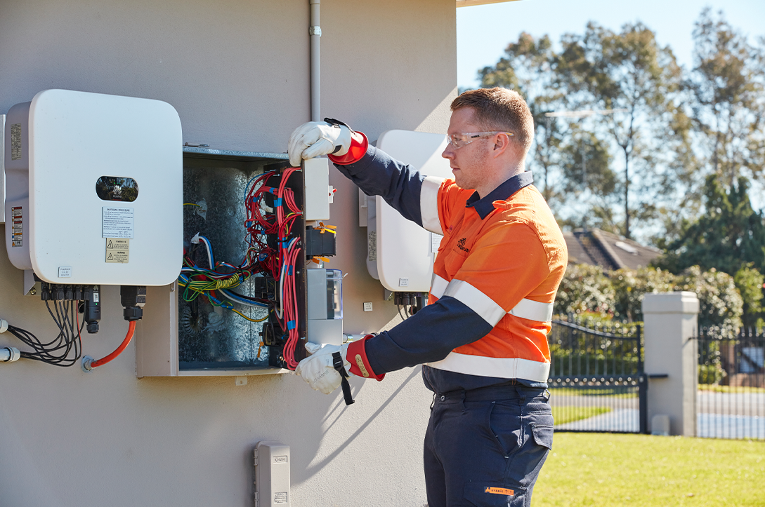 A photo of an electrician working on a smart meter.
