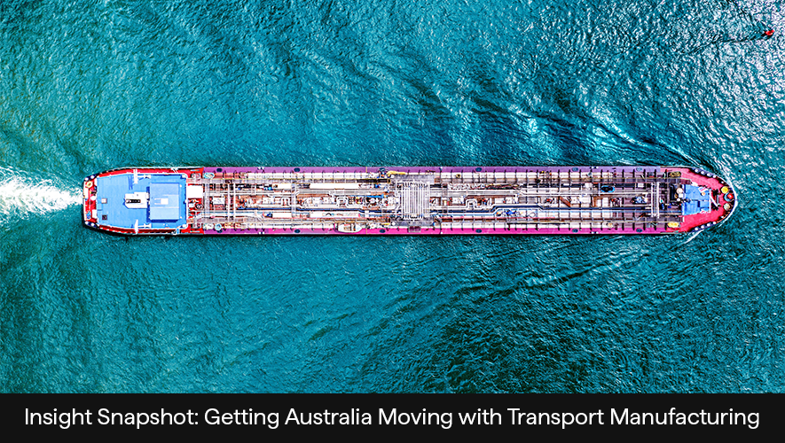 An overhead photo of a container ship travelling through water.