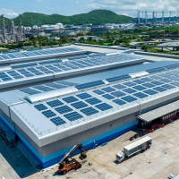 A photo of a factory with solar panels.