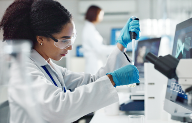 A photo of a woman working in a medical laboratory.