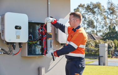 A photo of an electrician working on a smart meter.