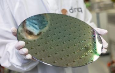 A photo of a technician holding a semiconductor.