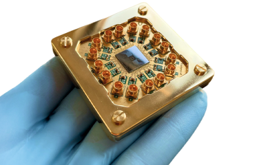 A photo of a person holding a quantum computer device.