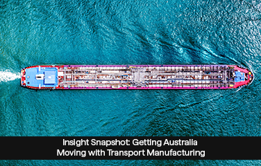 An overhead photo of a container ship travelling through water.